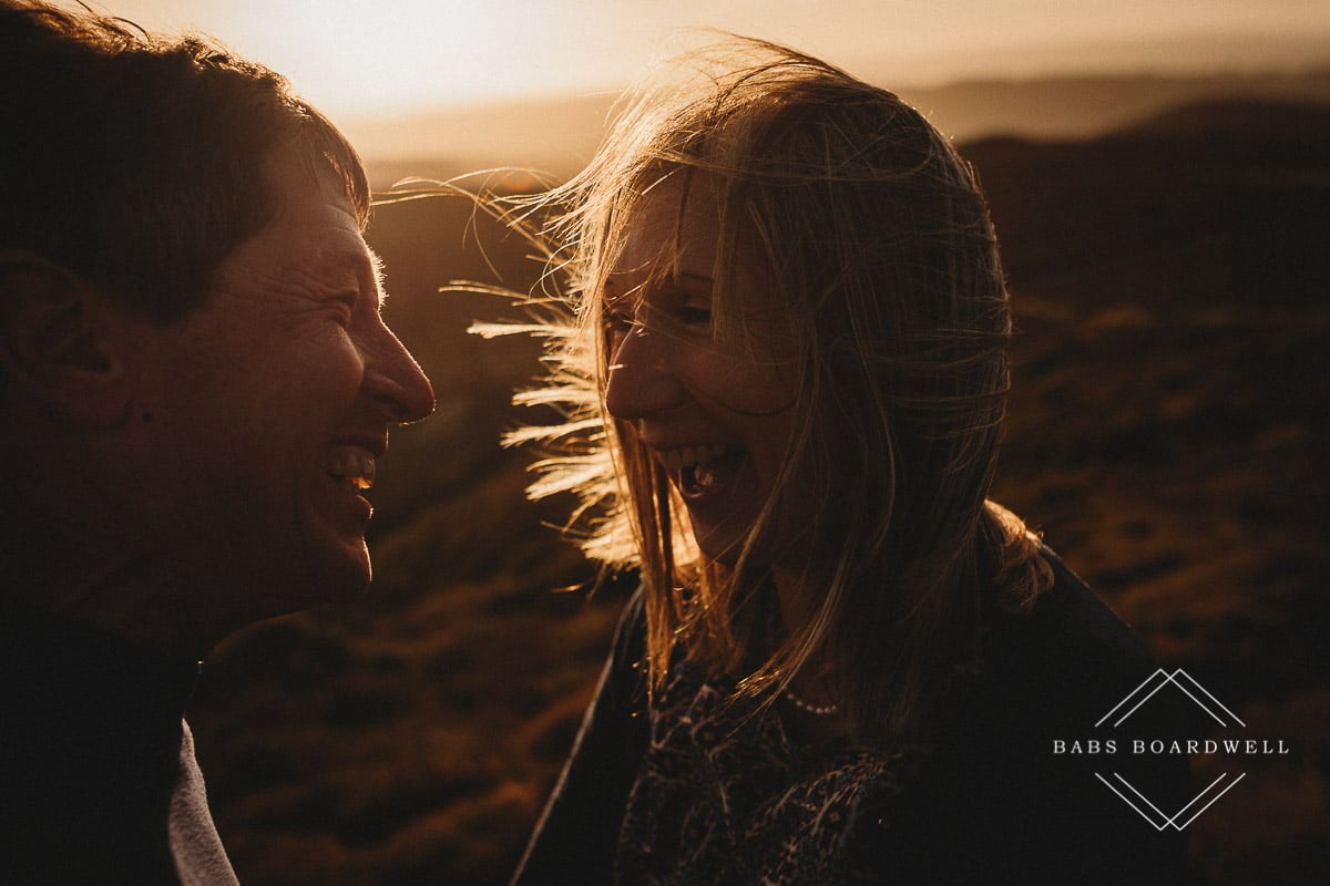 close-up of couple at sunset smiling at each other