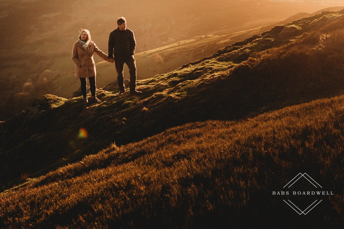 couple holding hands at sunset by Denbigh Wedding Photographer