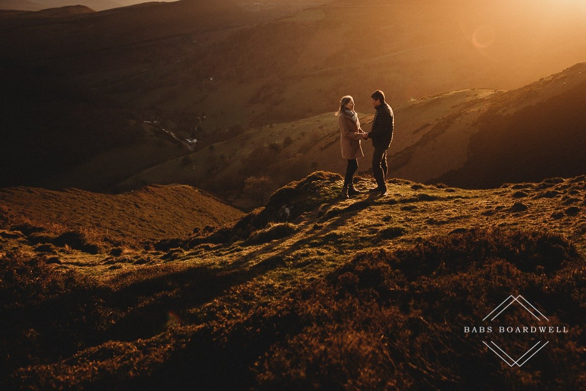 couple holding hands in the hills at sunset by Denbigh Wedding Photographer