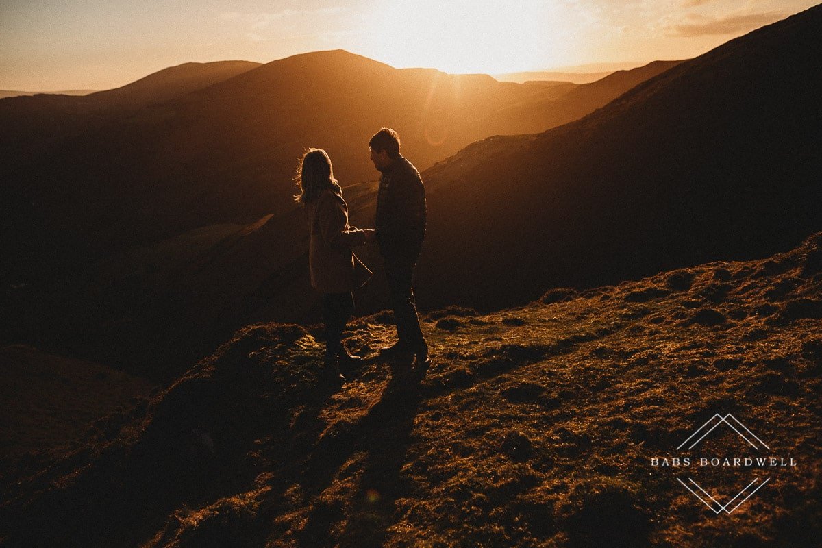 couple holding hands at sunset in North Wales