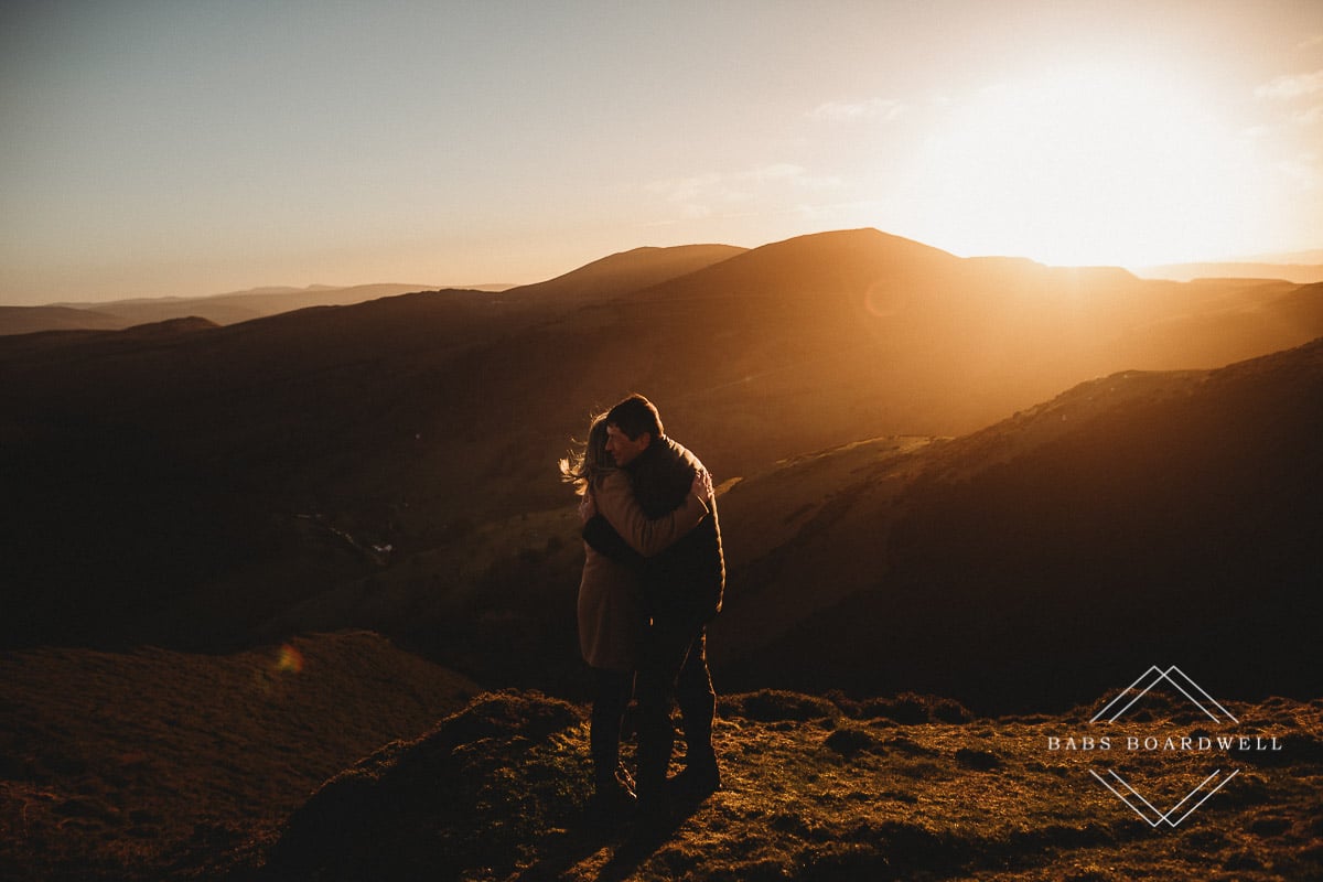 couple hugging each other at sunset