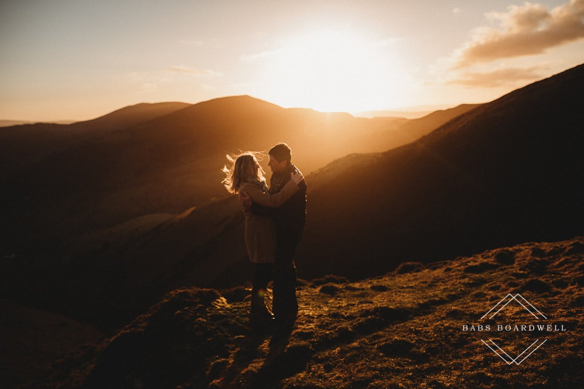 couple hugging and looking at each other at sunset in North Wales by Denbigh Wedding Photographer