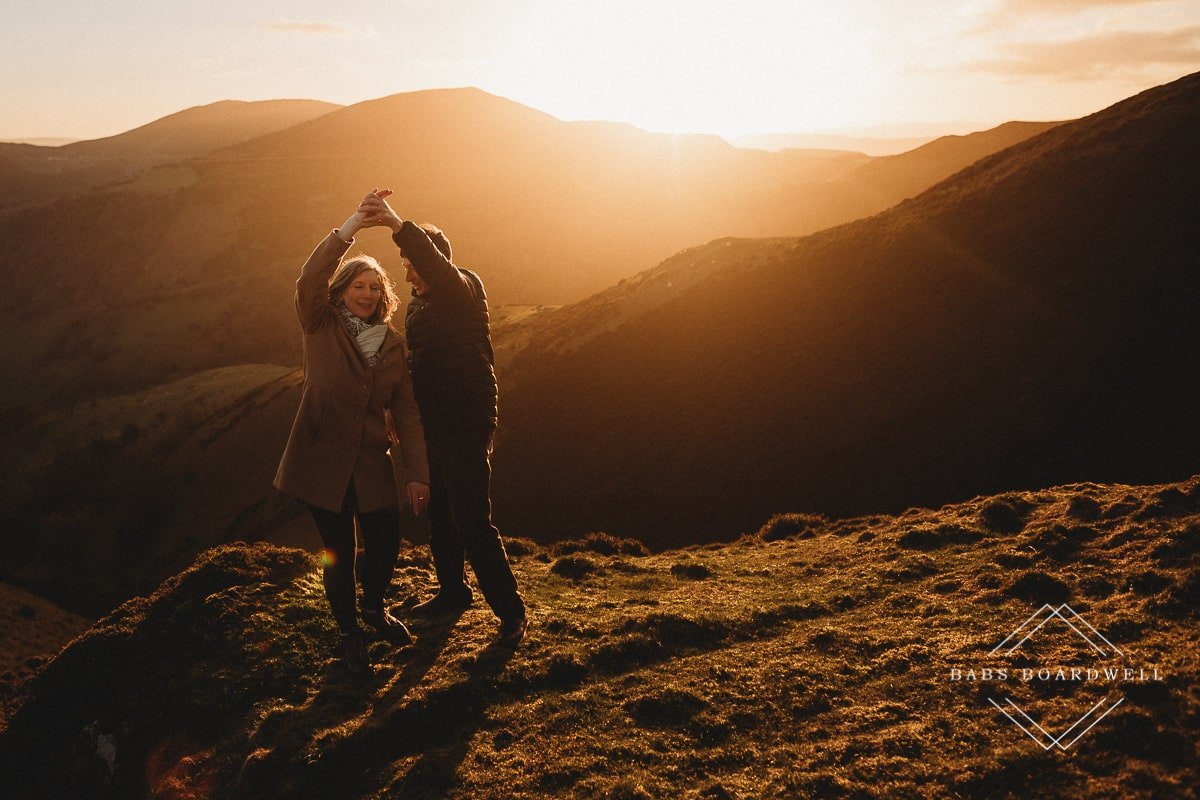 couple twirling at sunset in the hills in Llangollen