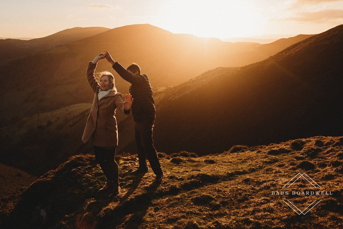 couple twirling at sunset in the Welsh hills by Denbigh Wedding Photographer