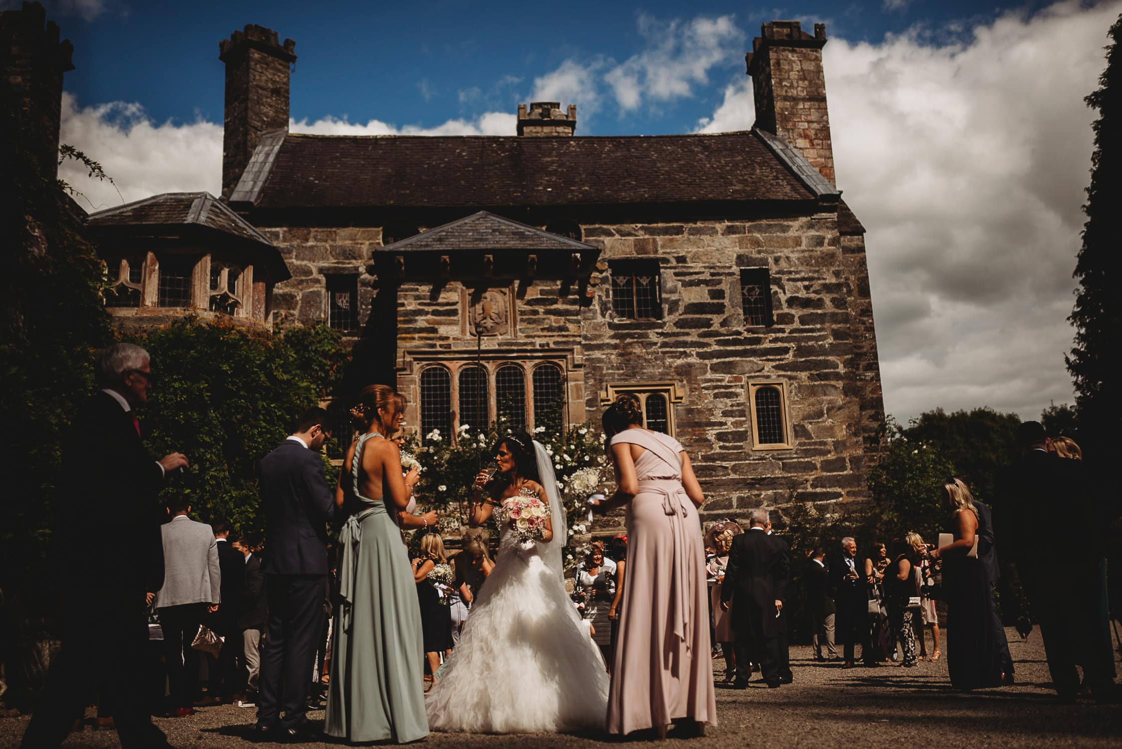 bride sipping champagne in front of Gwydir Castle 