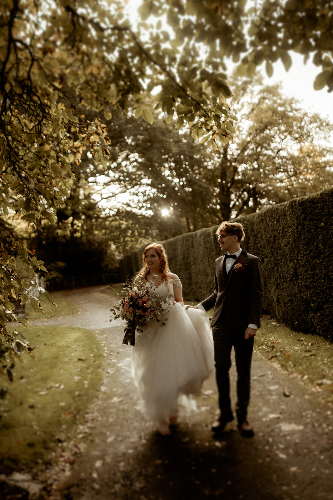 natural wedding photography in Wales | couple walking through the grounds at Treberfydd House