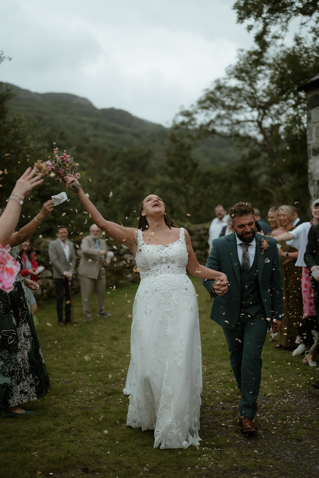 bride and groom and confetti at Llyn Gwynant