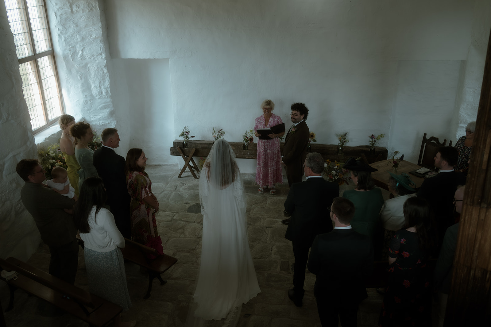 bride walking towards groom at the beginning of their micro wedding ceremony at Penarth Fawr