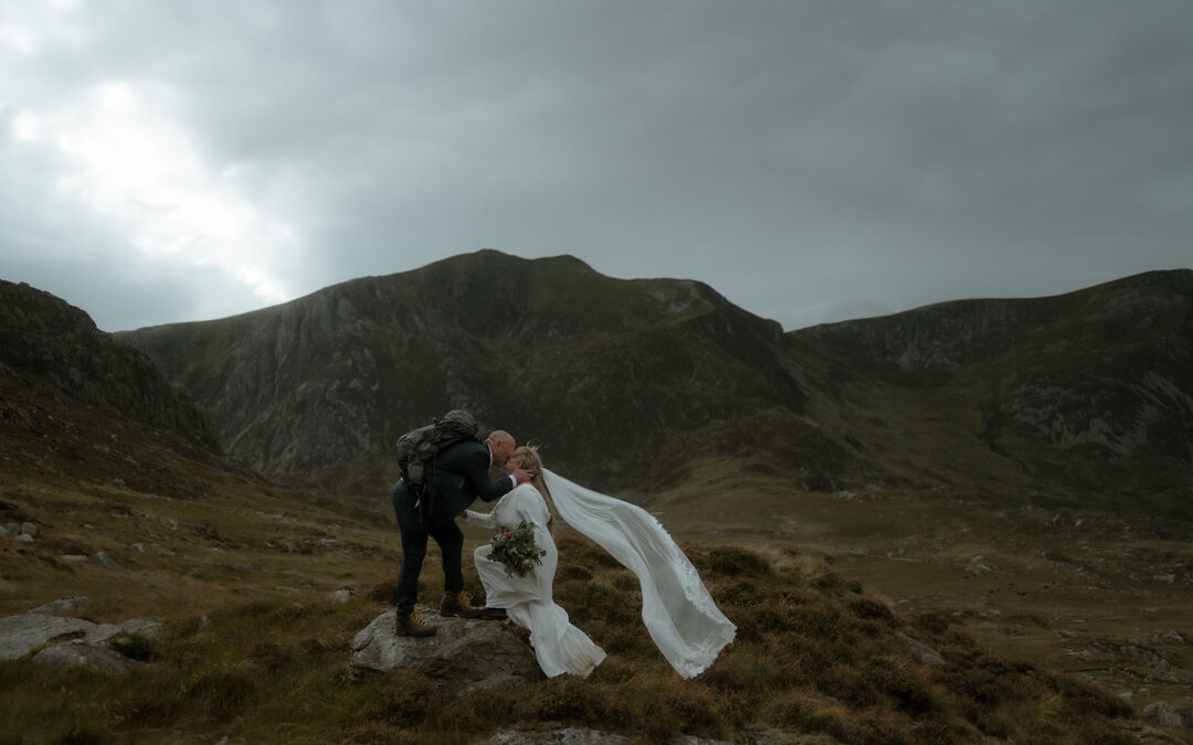 couple kissing in the mountains of Eryri following their small legal wedding ceremony at Chateau Rhianfa